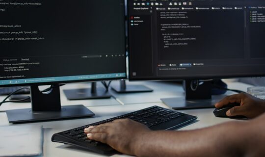 Programmer in server farm workspace protecting data threatened by hacking attacks on computers. IT professional writing code, safeguarding data center from unauthorized access, camera B close up